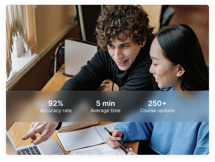 Two students in the UK studying together with a laptop and notes, collaborating and focused.